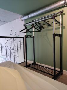 a metal bed frame in a room with a wall at Apartament AirPort in Wrocław