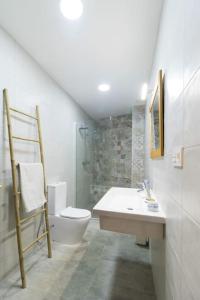 Un baño blanco con inodoro y lavabo. en Huétor Vega precioso apartamento, en Huétor Vega