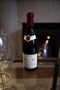 a bottle of wine sitting on a table with two glasses at *OKALEE* in Dinan