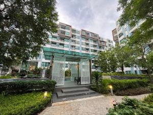 an apartment building with a glass facade and a courtyard at 1 bedroom Centrio Condominium Phuket Near Central Festival in Phuket town in Phuket Town