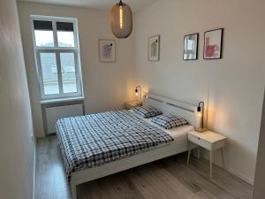 a bedroom with a bed and two lamps and a window at Lovely 2-bedroom apartment in centre of Bratislava in Bratislava