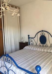 a blue and white bed in a bedroom at antica dimora in Barbarano Romano