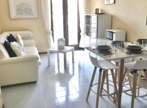 a living room with a table and a refrigerator at Il Cavalluccio in Grado