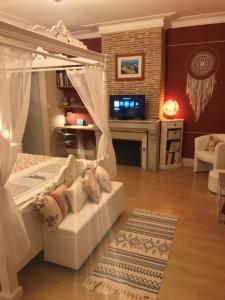 a bedroom with a white bed with a canopy at les trois tilleuls in Loupiac-de-Cadillac