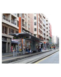 un edificio en una calle de la ciudad con gente sentada afuera en Dream Central Teatro, en Santa Cruz de Tenerife