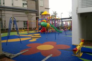 a playground with a slide and a play structure at Shaftsbury residence cyberjaya with a pool & Free Parking in Cyberjaya
