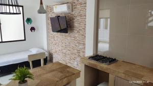 a small kitchen with a stove in a room at Cabaña 8 Arrecifes in Coveñas
