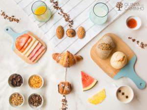 a table with various pastries and drinks on it at Quinta do Caminho, AL in Valença