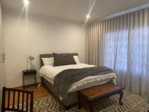 a bedroom with a large bed and a window at Cipresso Guesthouse in Tierpoort +18 photos