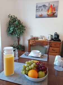 a table with a bowl of fruit and a bottle of orange juice at Victorian Renovation Room 7 in Liverpool