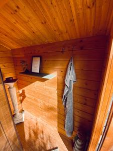 a sauna with a towel hanging from a wooden ceiling at Holzhütte Ole zw. Meer & Wald mit Kamin & Sauna in Behrensdorf