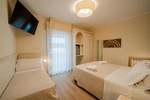Postel nebo postele na pokoji v ubytování Hotel Orchidea