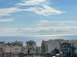 a view of a city with buildings and the ocean at Nice Renting - CAMBRAI - Luxurious Sea View Terrasse - King Bed - Parking - AC - fully equipped in Nice