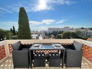 a table and chairs on a balcony with a view at Nice Renting - CAMBRAI - Luxurious Sea View Terrasse - King Bed - Parking - AC - fully equipped in Nice