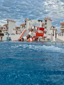 a water slide in a pool in a resort at Studio on the ground floor in Sharm Hills Resort with private garden and pool view in Sharm El Sheikh