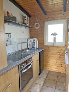 a kitchen with a sink and a stove at "Haus am Meer"Fewo 2 - a71226 in Butjadingen