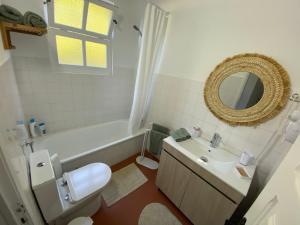 a bathroom with a toilet and a sink and a mirror at Ribeira do Guilherme - Watermill house Botanic Garden in Nordeste