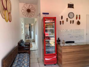 a red refrigerator in a kitchen next to a counter at Pousada Meu Xodó in Barreirinhas
