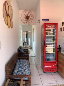 a coca cola refrigerator in a room with a bench at Pousada Meu Xodó in Barreirinhas