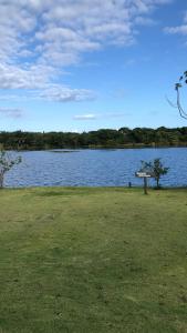 vista lago con un cartello sull'erba di Apartamento Cobertura Paraíso das Águas - GUARAJUBA a Camaçari