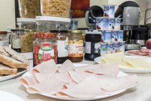 a counter with plates of food and other ingredients at Budapest B&B Bed and Breakfast in Budapest