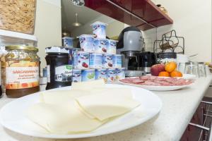 a kitchen counter with plates of food on it at Budapest B&B Bed and Breakfast in Budapest