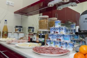 a kitchen counter with meat and other food items at Budapest B&B Bed and Breakfast in Budapest
