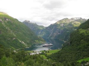 a cruise ship in a river in a mountain valley at Lunheim in Geiranger in Geiranger