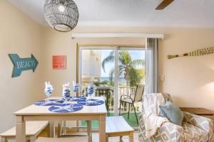 a dining room with a table and chairs and a patio at 201 Belleair Beach Club in Clearwater Beach