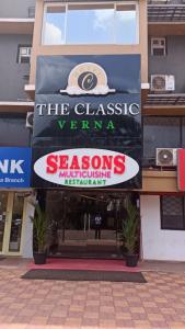 a sign on the side of a building at Hotel The Classic Verna in Verna