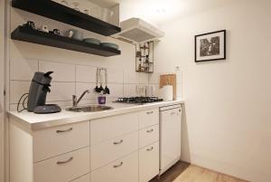 a white kitchen with a sink and a stove at Appartementen Purmerend B in Purmerend