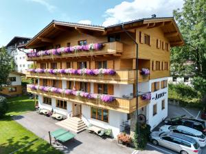 an apartment building with flowers on the balconies at Appartement Pension Auhof in Going