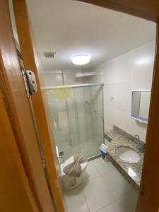 a bathroom with a shower and a toilet and a sink at Apartamento Cobertura Paraíso das Águas - GUARAJUBA in Camaçari