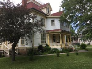 a large white house with a red roof at Marmora and Lake Inn and Victorian Diner in Marmora