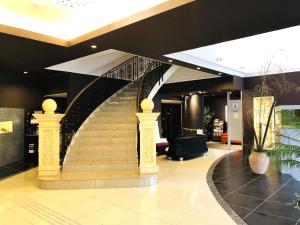 a lobby with a spiral staircase in a building at Hotel Square FujiGotemba in Gotemba