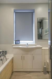 a bathroom with a sink and a window at Spacious 5 Bedroom House in Birmingham close to NEC For 12 Guests in Birmingham
