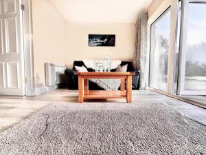 a living room with a table and a couch at Long Acre Lodge 