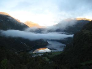 a view of a valley with a lake in the middle at Lunheim in Geiranger in Geiranger