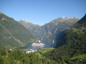 a cruise ship in a lake in the mountains at Lunheim in Geiranger in Geiranger