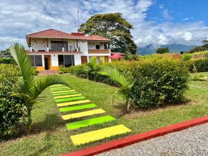 a house with yellow steps in front of it at Casa Campestre Denis in Guamal