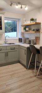 a kitchen with a sink and a table and a window at Apartment in Letterkenny