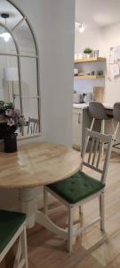 a table and chairs in a room with a kitchen at Apartment in Letterkenny