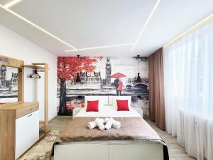 a bedroom with a bed and a painting on the wall at Cozy Apartment in Pristina in Pristina