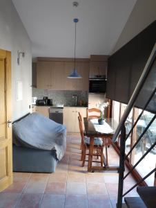 a kitchen and dining room with a table and a bed at Apartament luxe Rural Adrall -La Seu d'Urgell-Andorra in Adrall