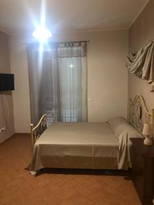 Un dormitorio con una cama grande con una luz sobre ella en Villa Castaldo, en Castiglion Fiorentino