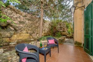 a patio with two chairs and a table with a bottle on it at Djar Ta Menzja 1 Holiday Home in Sannat