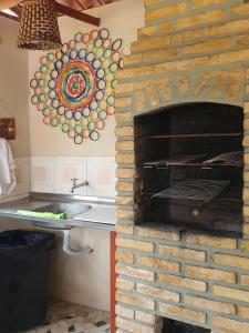a brick oven in a kitchen with a sink at Antunes vila maragogi in Maragogi