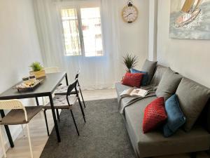 a living room with a couch and a table at Apartment near the BIO PARC in Valencia