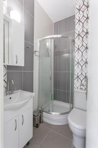 a bathroom with a sink and a toilet and a shower at Karpaz Sunset Hotel in Rizokarpaso