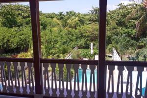 a view from a balcony looking out at a yard at Beach house with nice private pool ,baie orientale in Orient Bay